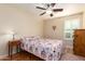 Charming bedroom with floral bedding and wood floors at 21836 W Hopi St, Buckeye, AZ 85326