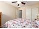 Bedroom with floral bedding and ceiling fan at 21836 W Hopi St, Buckeye, AZ 85326