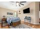 Bright bedroom featuring a ceiling fan and large TV at 21836 W Hopi St, Buckeye, AZ 85326