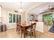 Kitchen dining area with wooden table and chairs, near sliding door at 21836 W Hopi St, Buckeye, AZ 85326