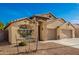 Tan two-car garage home with desert landscaping at 21836 W Hopi St, Buckeye, AZ 85326