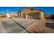 Two-car garage with large driveway and desert landscaping at 21836 W Hopi St, Buckeye, AZ 85326