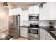 Modern kitchen with stainless steel appliances and white cabinets at 21836 W Hopi St, Buckeye, AZ 85326