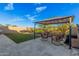 Artificial turf backyard with a covered patio and seating area at 28965 N 120Th Dr, Peoria, AZ 85383