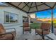 Covered patio with seating area, artificial turf, and a view of the backyard at 28965 N 120Th Dr, Peoria, AZ 85383