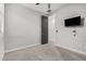 Bedroom with mounted TV and carpet flooring at 28965 N 120Th Dr, Peoria, AZ 85383