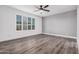 Spacious bedroom featuring wood-look floors and ceiling fan at 28965 N 120Th Dr, Peoria, AZ 85383