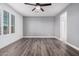 Comfortable bedroom with wood-look floors and access to bathroom at 28965 N 120Th Dr, Peoria, AZ 85383