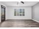 Bright bedroom with wood-look floors and large window with plantation shutters at 28965 N 120Th Dr, Peoria, AZ 85383