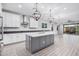 Open kitchen with island, stainless steel appliances, and access to backyard at 28965 N 120Th Dr, Peoria, AZ 85383
