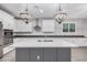 Bright kitchen with white cabinets, a large island, and marble backsplash at 28965 N 120Th Dr, Peoria, AZ 85383