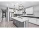 Elegant kitchen boasting white cabinets, an island, and pendant lighting at 28965 N 120Th Dr, Peoria, AZ 85383