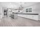 Spacious kitchen featuring white cabinets, an island, and stylish light fixtures at 28965 N 120Th Dr, Peoria, AZ 85383