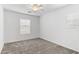 Bright bedroom with carpet, ceiling fan, and window blinds at 40925 W Patricia Ln, Maricopa, AZ 85138