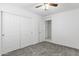 Bright bedroom with double door closet and carpet at 40925 W Patricia Ln, Maricopa, AZ 85138