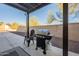 Outdoor grilling area with a gas grill and patio seating at 4510 N Pierce Ct, Buckeye, AZ 85396