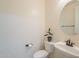 Simple bathroom with toilet, sink, and oval mirror at 4510 N Pierce Ct, Buckeye, AZ 85396