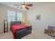 Bedroom with red bedding and ceiling fan at 4510 N Pierce Ct, Buckeye, AZ 85396