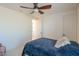 Well-lit bedroom with ceiling fan and blue bedding at 4510 N Pierce Ct, Buckeye, AZ 85396