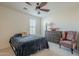 Bedroom with a queen bed and an armchair at 4510 N Pierce Ct, Buckeye, AZ 85396