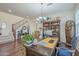 Home office with a large desk, hardwood floors, and a view into living room at 4510 N Pierce Ct, Buckeye, AZ 85396