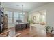 Home office with large desk, built-in bookcase, and hardwood floors at 4510 N Pierce Ct, Buckeye, AZ 85396