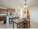 Open kitchen features an island with seating, updated appliances, and wood cabinets at 4510 N Pierce Ct, Buckeye, AZ 85396