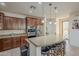 Modern kitchen with granite island, stainless steel appliances, and wood cabinets at 4510 N Pierce Ct, Buckeye, AZ 85396