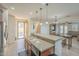Bright kitchen boasts an island with sink, granite counters & stainless steel appliances at 4510 N Pierce Ct, Buckeye, AZ 85396