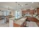 Open kitchen features granite island, stainless steel appliances, and breakfast bar at 4510 N Pierce Ct, Buckeye, AZ 85396
