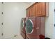 Laundry room with washer, dryer, cabinets, and sink at 4510 N Pierce Ct, Buckeye, AZ 85396