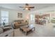 Relaxing living room with ceiling fan, large windows, and neutral decor at 4510 N Pierce Ct, Buckeye, AZ 85396