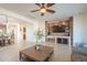Spacious living room with stone fireplace and large flat-screen TV at 4510 N Pierce Ct, Buckeye, AZ 85396