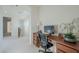 Home office with desk, chair, and open floor plan at 4510 N Pierce Ct, Buckeye, AZ 85396