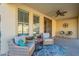 Peaceful patio with wicker furniture, ceiling fan, and view of the pool at 4510 N Pierce Ct, Buckeye, AZ 85396