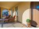 Covered porch with wicker furniture, creating a relaxing space at 4510 N Pierce Ct, Buckeye, AZ 85396