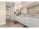 Elegant bathroom with double vanity, granite countertop, and large shower at 5273 N 207Th Dr, Buckeye, AZ 85396