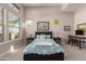 Bright bedroom with large windows, carpeted floors, and a built-in workspace at 5273 N 207Th Dr, Buckeye, AZ 85396