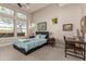 Bright bedroom with large windows, carpeted floors, and a built-in workspace at 5273 N 207Th Dr, Buckeye, AZ 85396