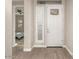 Bright entryway with interior door and built-in shelving at 5273 N 207Th Dr, Buckeye, AZ 85396