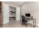 Home office with desk, chair, and built-in shelving at 5273 N 207Th Dr, Buckeye, AZ 85396