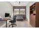 Home office with a desk, chair, and sofa at 5273 N 207Th Dr, Buckeye, AZ 85396