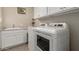 Convenient laundry room with washer, dryer, and cabinets at 5273 N 207Th Dr, Buckeye, AZ 85396