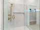 Walk-in shower with marble tile and gold fixtures at 5525 E Sandra Ter Ter, Scottsdale, AZ 85254