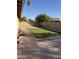 Landscaped backyard with artificial turf and a spa at 815 W Kiva Ave, Mesa, AZ 85210