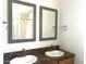 Double vanity bathroom with updated fixtures and mirrors at 9431 E Coralbell Ave # 124, Mesa, AZ 85208