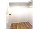 Walk-in closet with wood-look flooring and shelving at 9431 E Coralbell Ave # 124, Mesa, AZ 85208