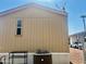 Tan mobile home exterior with A/C unit and satellite dish at 9431 E Coralbell Ave # 124, Mesa, AZ 85208