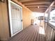 Covered porch with wooden deck and security door at 9431 E Coralbell Ave # 124, Mesa, AZ 85208