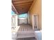 Covered porch with wooden deck and railing at 9431 E Coralbell Ave # 124, Mesa, AZ 85208
